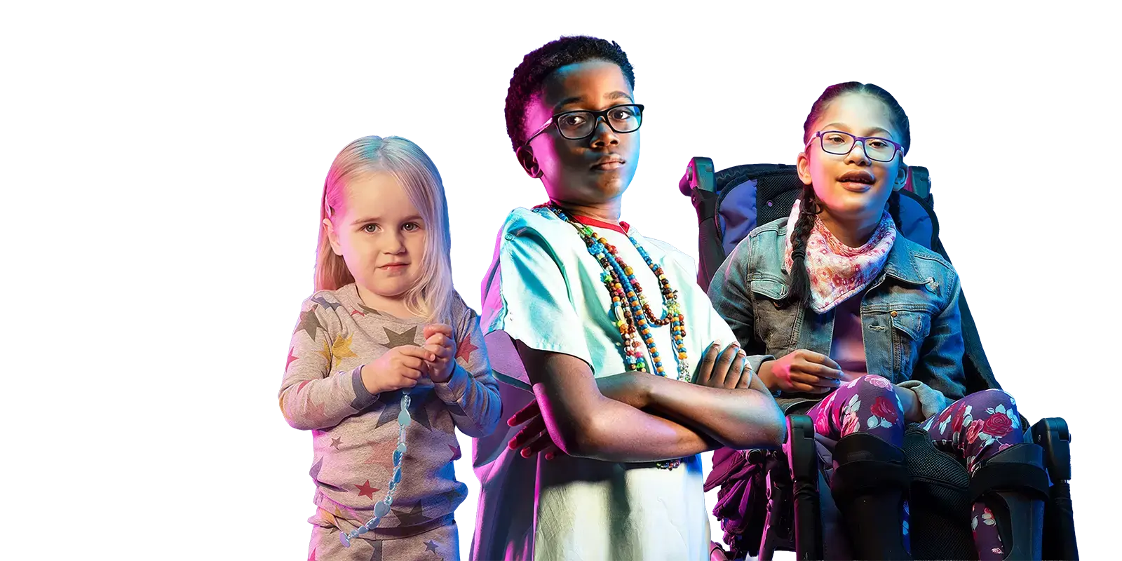 Three children posing together against a blue studio background, including a young girl holding beads, a boy wearing glasses and colorful necklaces, and a girl in a wheelchair smiling toward the camera under colorful lighting.
